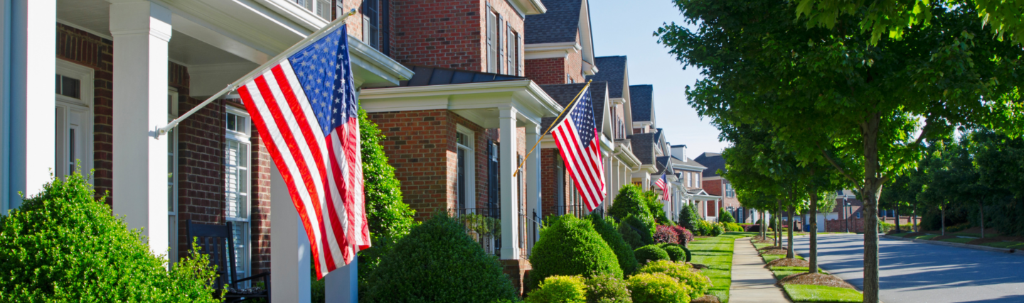 Row of homes with American flags