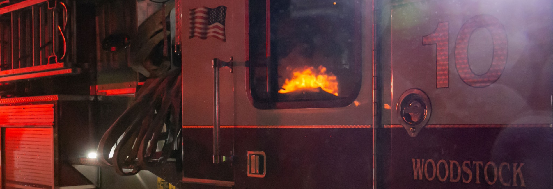 Fire reflected in fire truck window