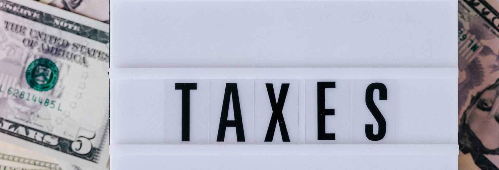 Tax Sign Laying on Money
