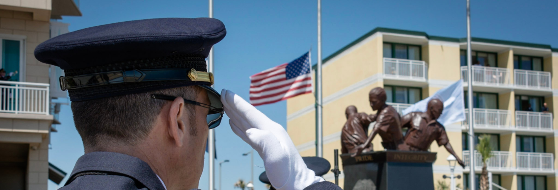 Honor guard officer saluting law enforcement officer memorial