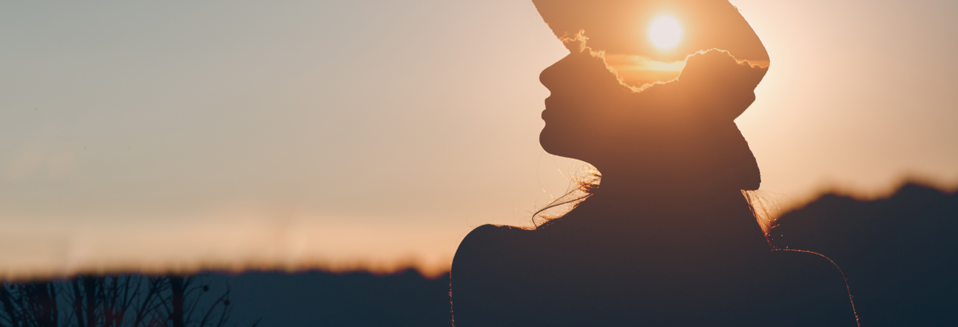 Woman sitting in front of sunrise BH header
