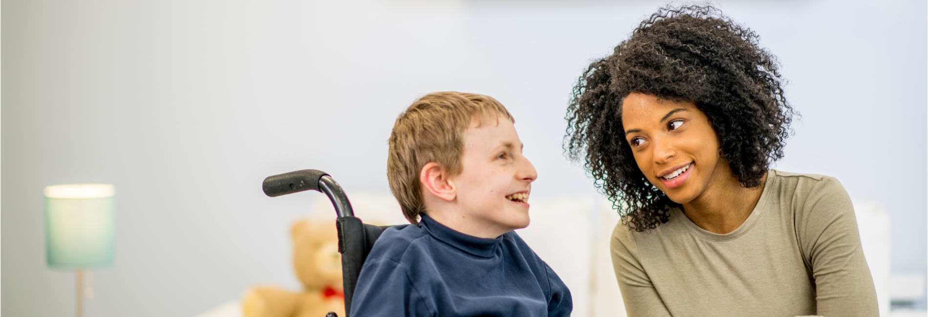 Woman talking to young man in wheelchair Developmental Services header
