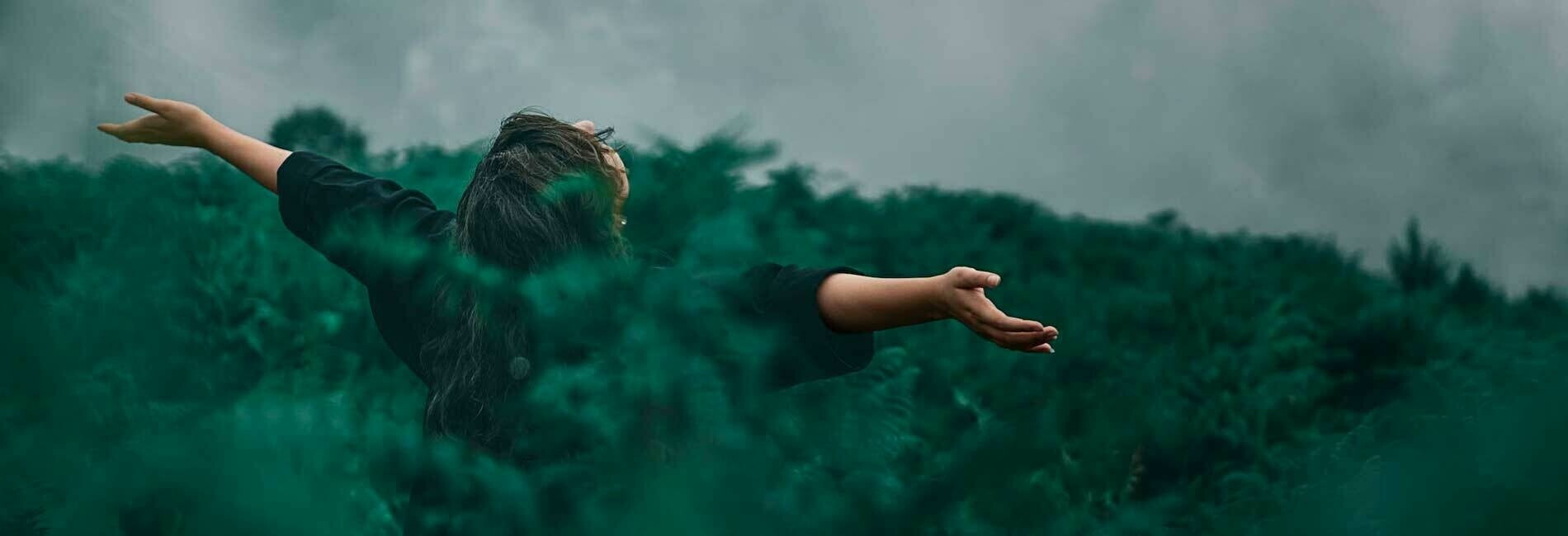 Woman in Field Looking at Sky