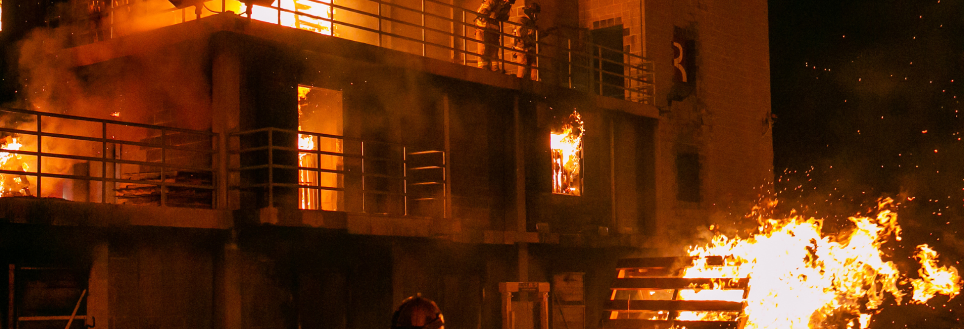 Fire training center burn training building on fire at night