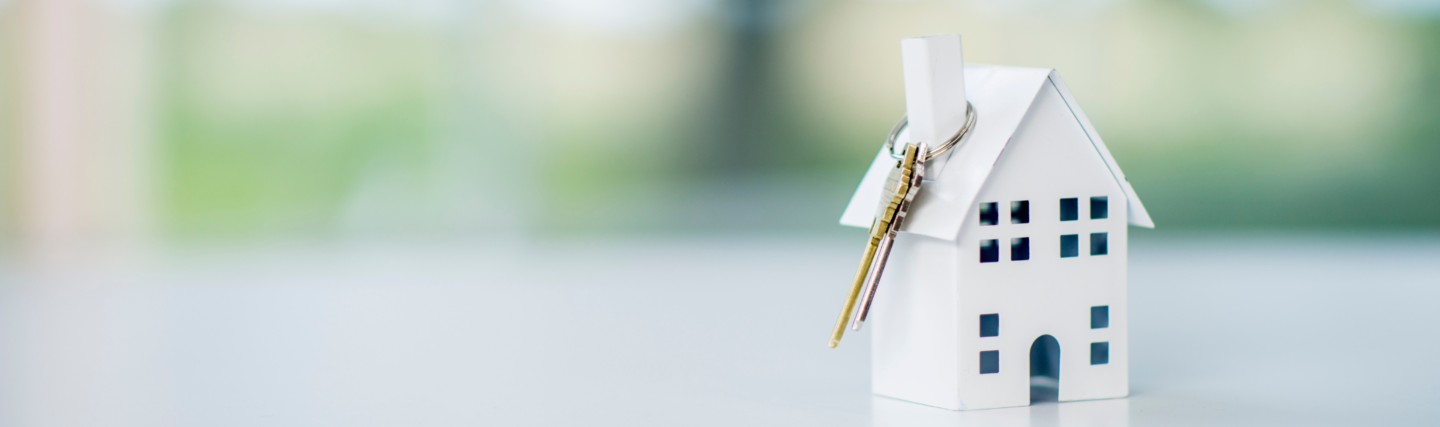 Paper model of the house with keys hanging from chimney