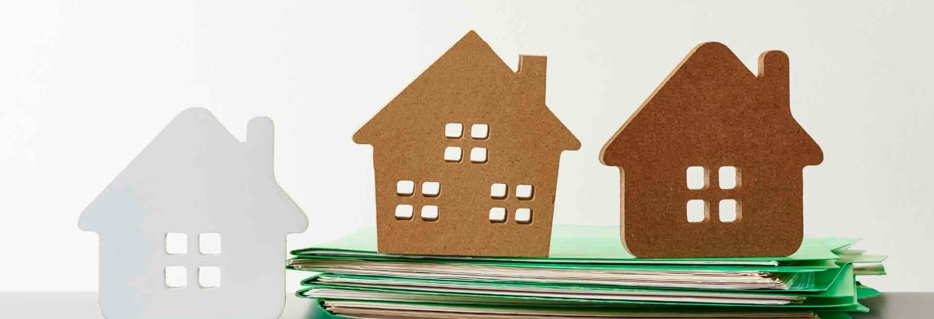 Carboard Houses on Stack of Files