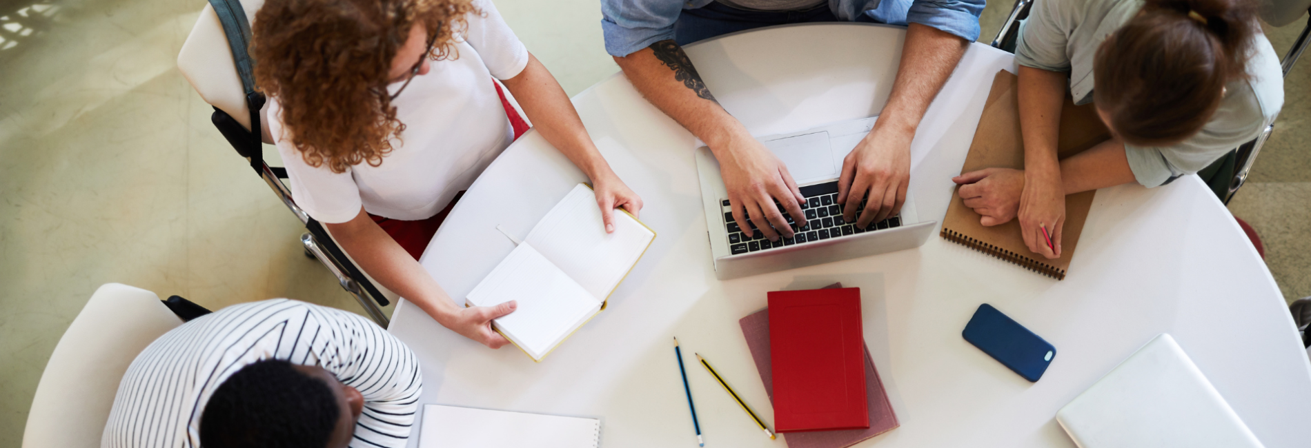 Four people sitting around a table talking Prevention Services header