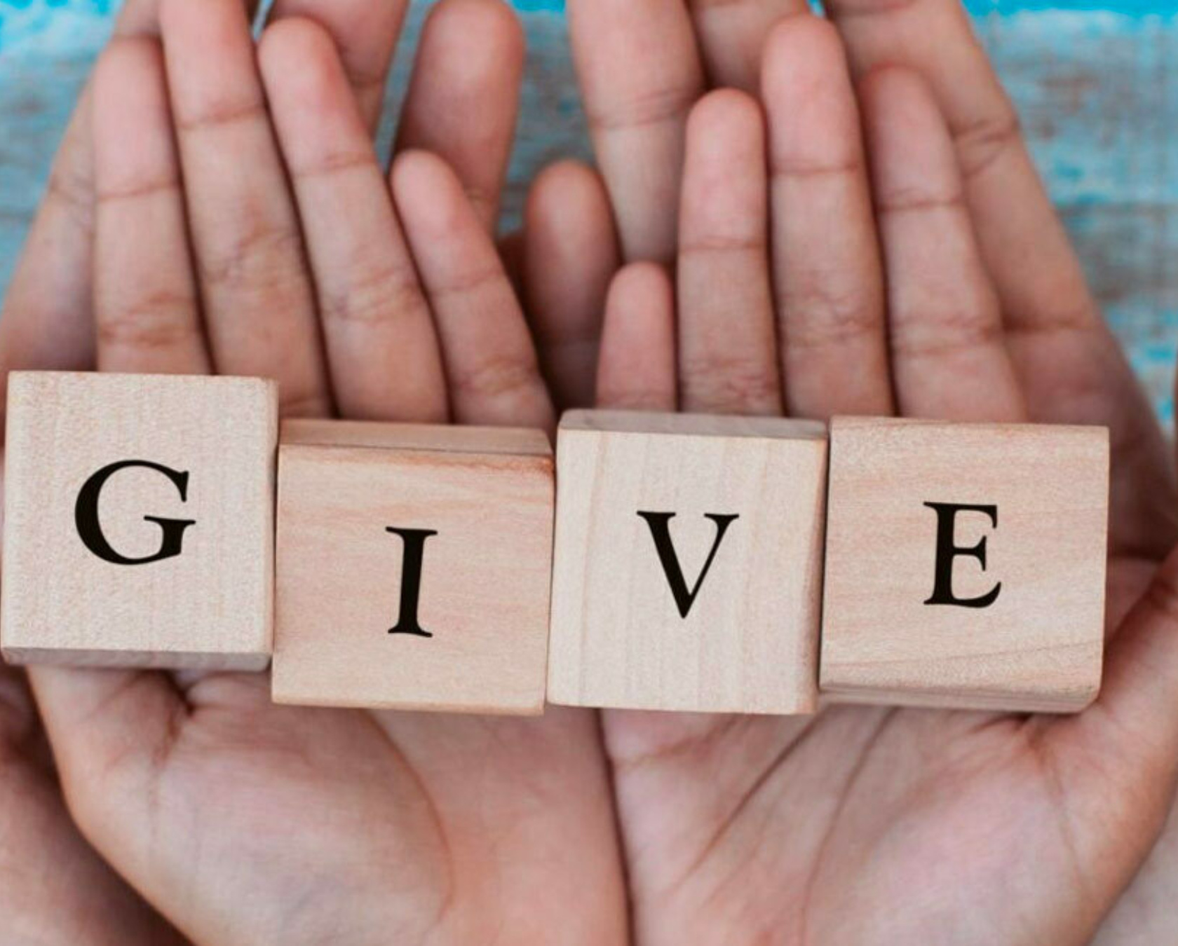 Hands Holding Blocks Spelling Give