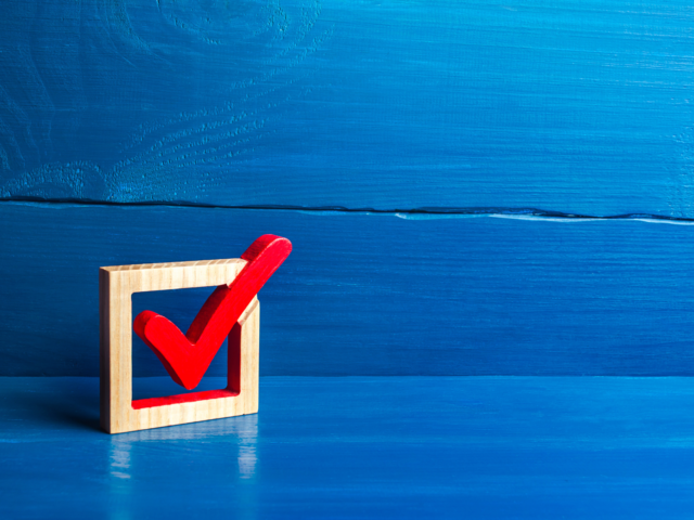 Red checkmark in wooden box